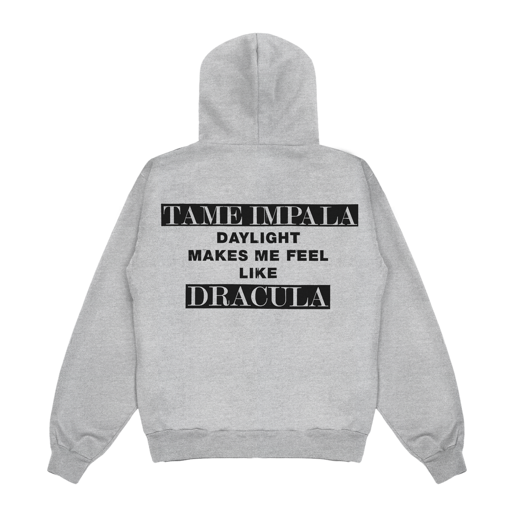 Grey hoodie featuring black text that reads “Tame Impala. Daylight makes me feel like Dracula.” The words “Tame Impala” and “Dracula” are printed in white against a black background.
